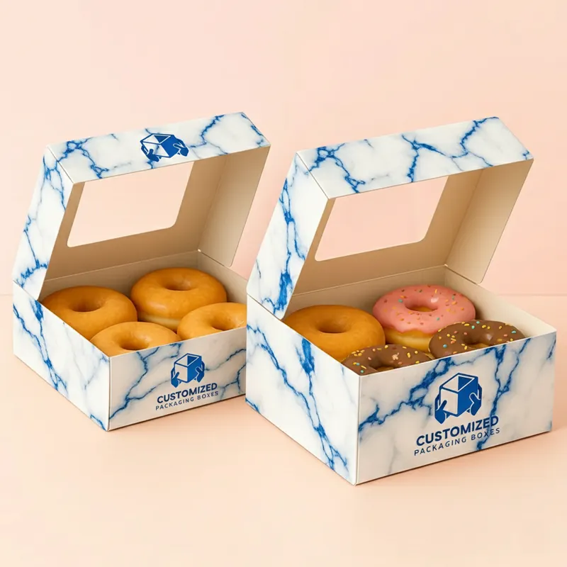 A pink donut box with the top open showcasing a row of round donuts inside.
