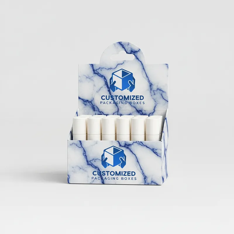 A colorful, patterned lip balm box in shades of pink, purple, and blue is displayed upright.
