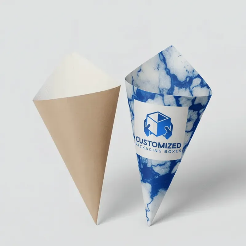 A box-shaped ice cream cone sleeve, likely used for packaging, is displayed.
